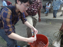 Peter Kang collects a water sample in Kiwilani, Tanzania
